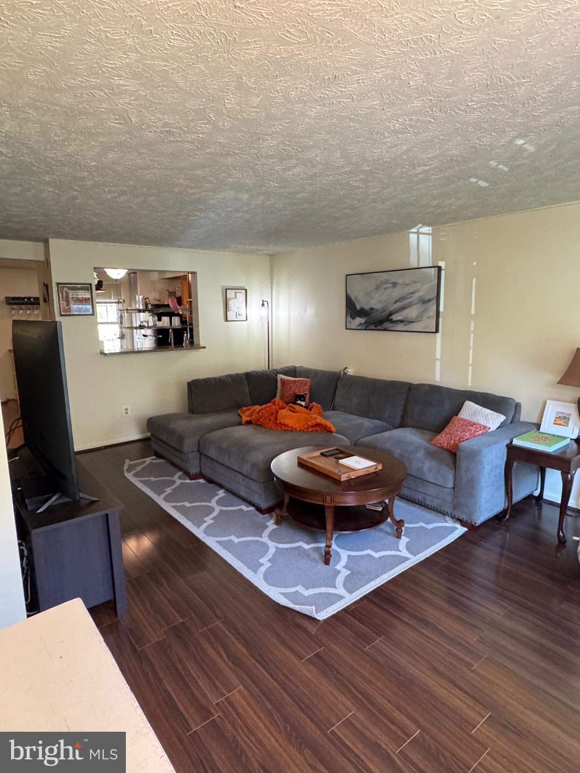 1565 Autumn Ridge Circle Reston, VA 20194 - Photo 2 of 19 a living room with furniture and a flat screen tv