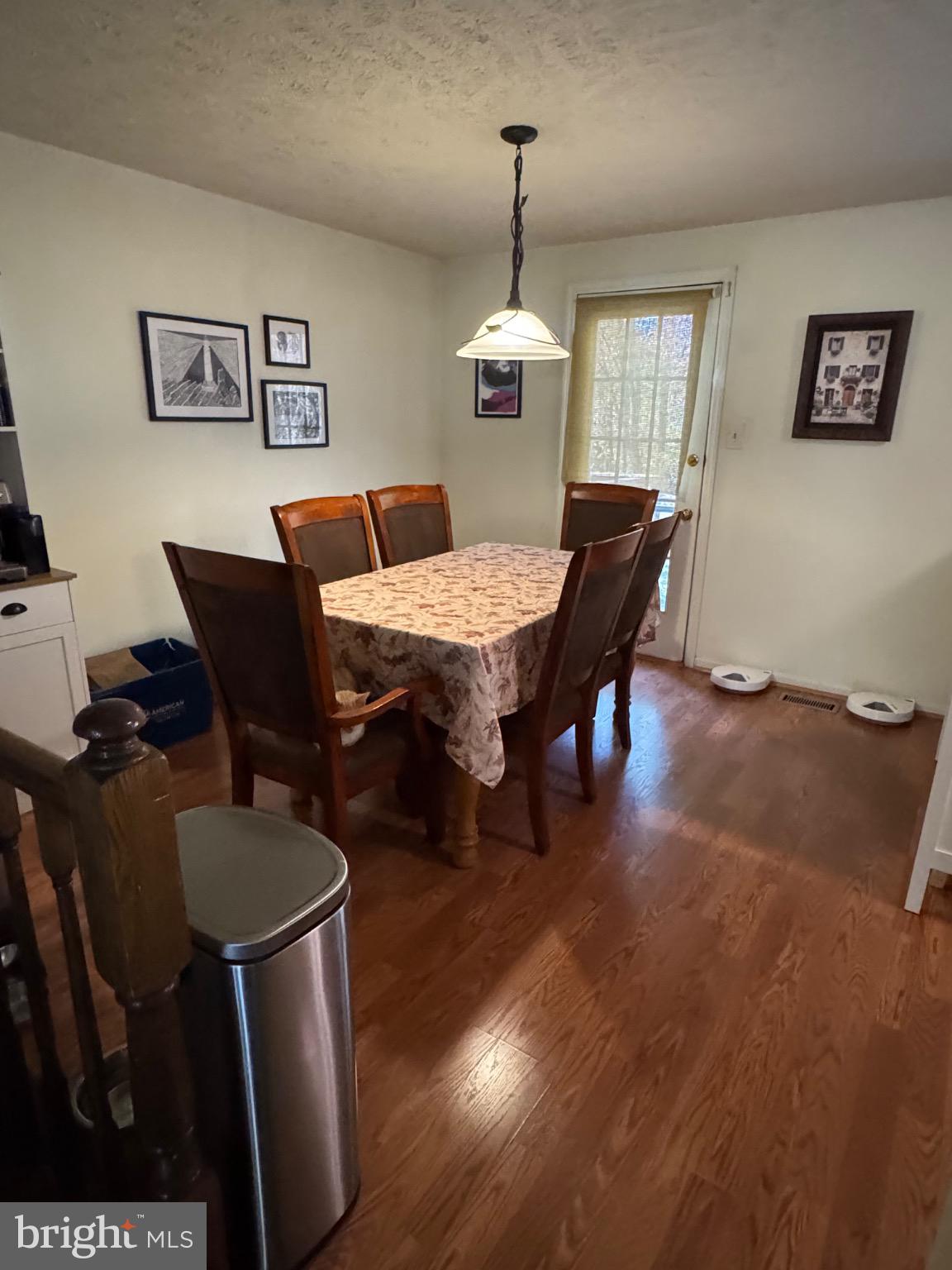 1565 Autumn Ridge Circle Reston, VA 20194 - Photo 5 of 19 a dining room with furniture a chandelier and wooden floor