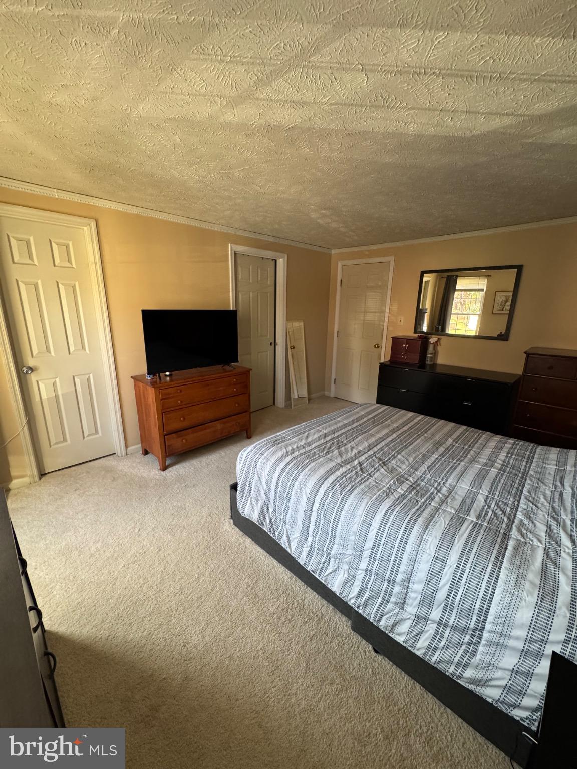 1565 Autumn Ridge Circle Reston, VA 20194 - Photo 8 of 19 a bedroom with a bed and a television