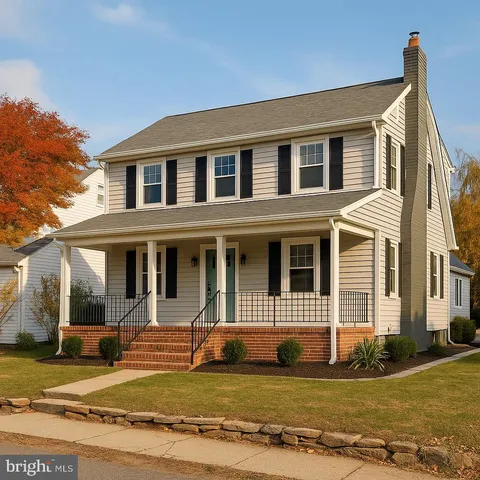 a view of a house with a big yard and large windows