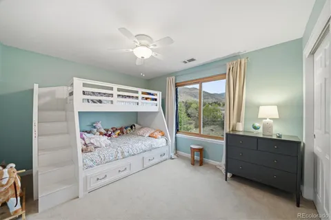 a bedroom with furniture and a large window