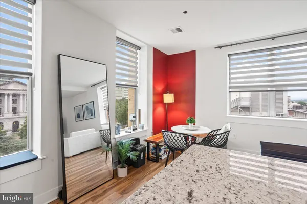 a bedroom with furniture and a large window