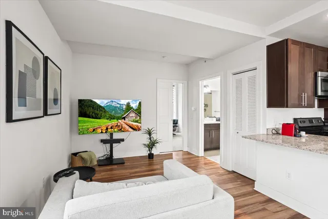 a living room with furniture and a flat screen tv
