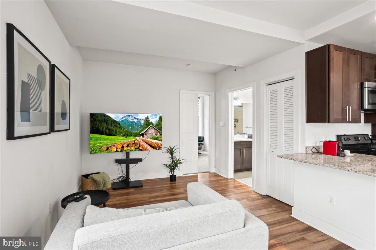 231 State Street, Unit 805 Harrisburg, PA 17101 - Photo 14 of 37 a living room with furniture and a flat screen tv