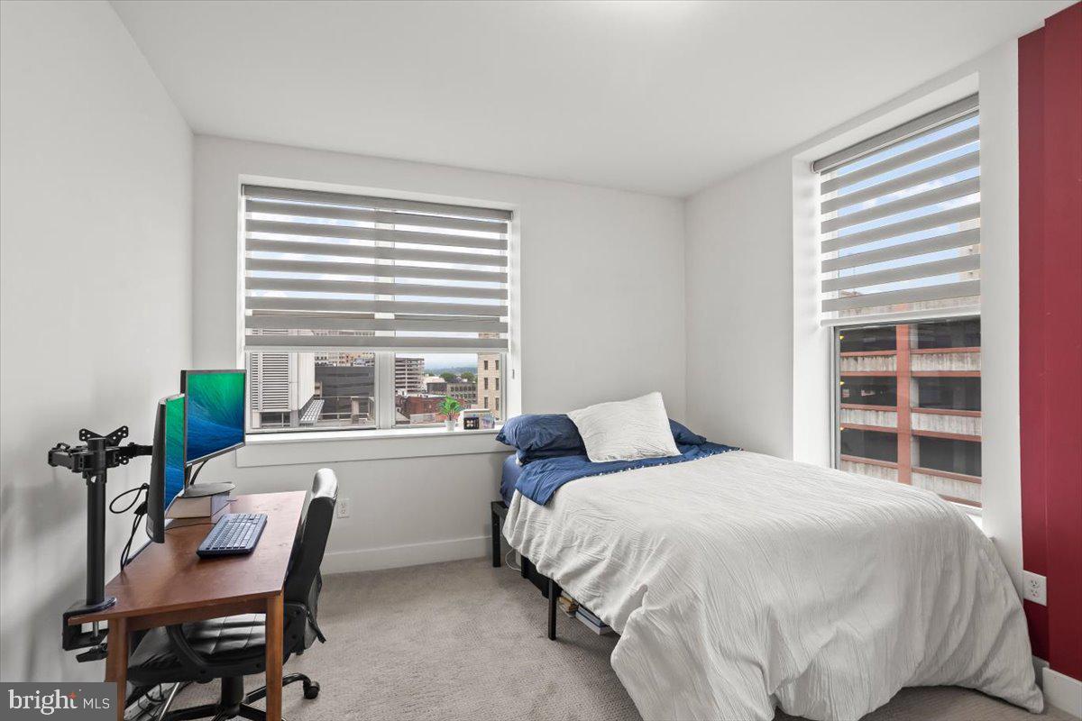 231 State Street, Unit 805 Harrisburg, PA 17101 - Photo 20 of 37 a bedroom with a bed and a chair