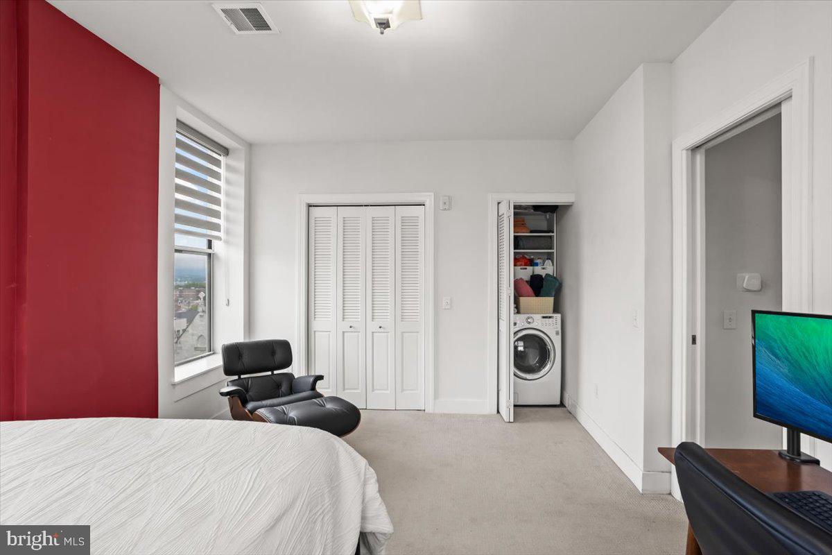 231 State Street, Unit 805 Harrisburg, PA 17101 - Photo 22 of 37 a bedroom with a bed and a flat screen tv