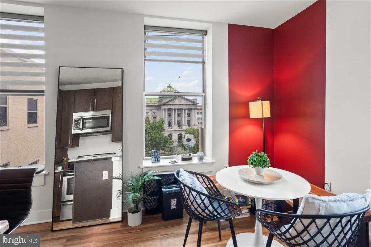 231 State Street, Unit 805 Harrisburg, PA 17101 - Photo 23 of 37 a view of a dining room with furniture window and wooden floor
