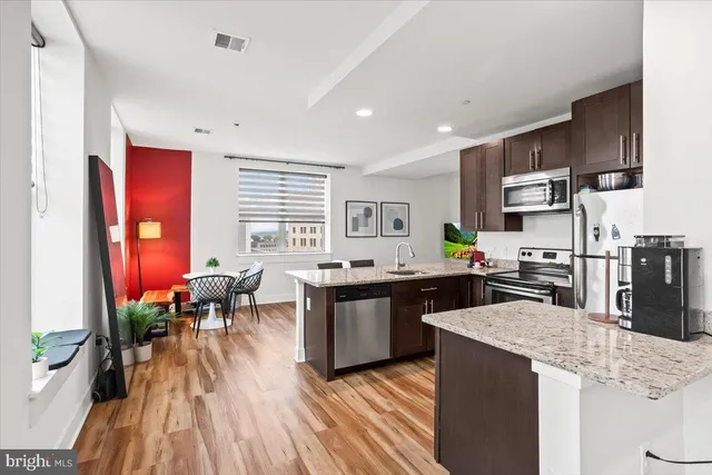 a kitchen with lots of counter top space and furniture