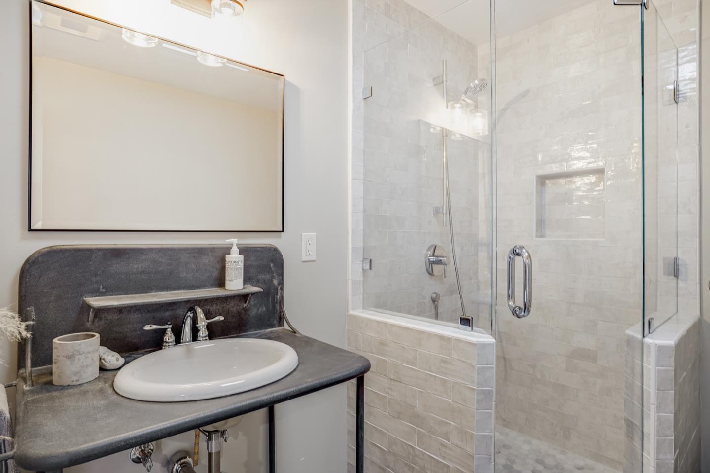 14150 Reservation Road Salinas, CA 93908 - Photo 23 of 47 a bathroom with a sink a toilet a mirror and shower
