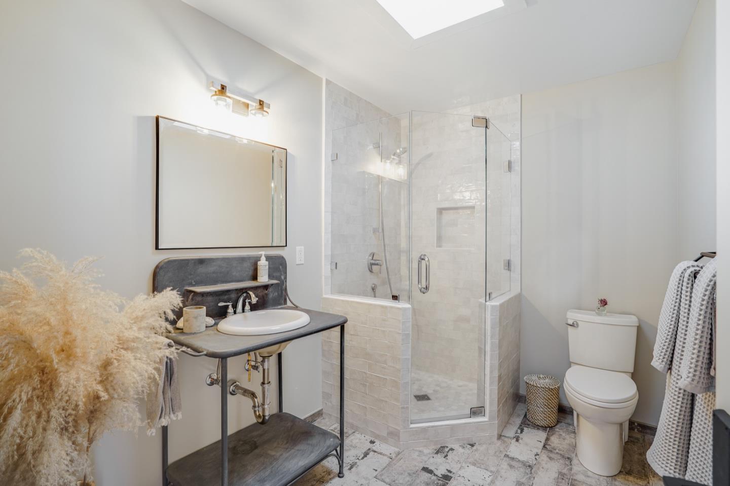 14150 Reservation Road Salinas, CA 93908 - Photo 24 of 47 a bathroom with a toilet a sink and a mirror