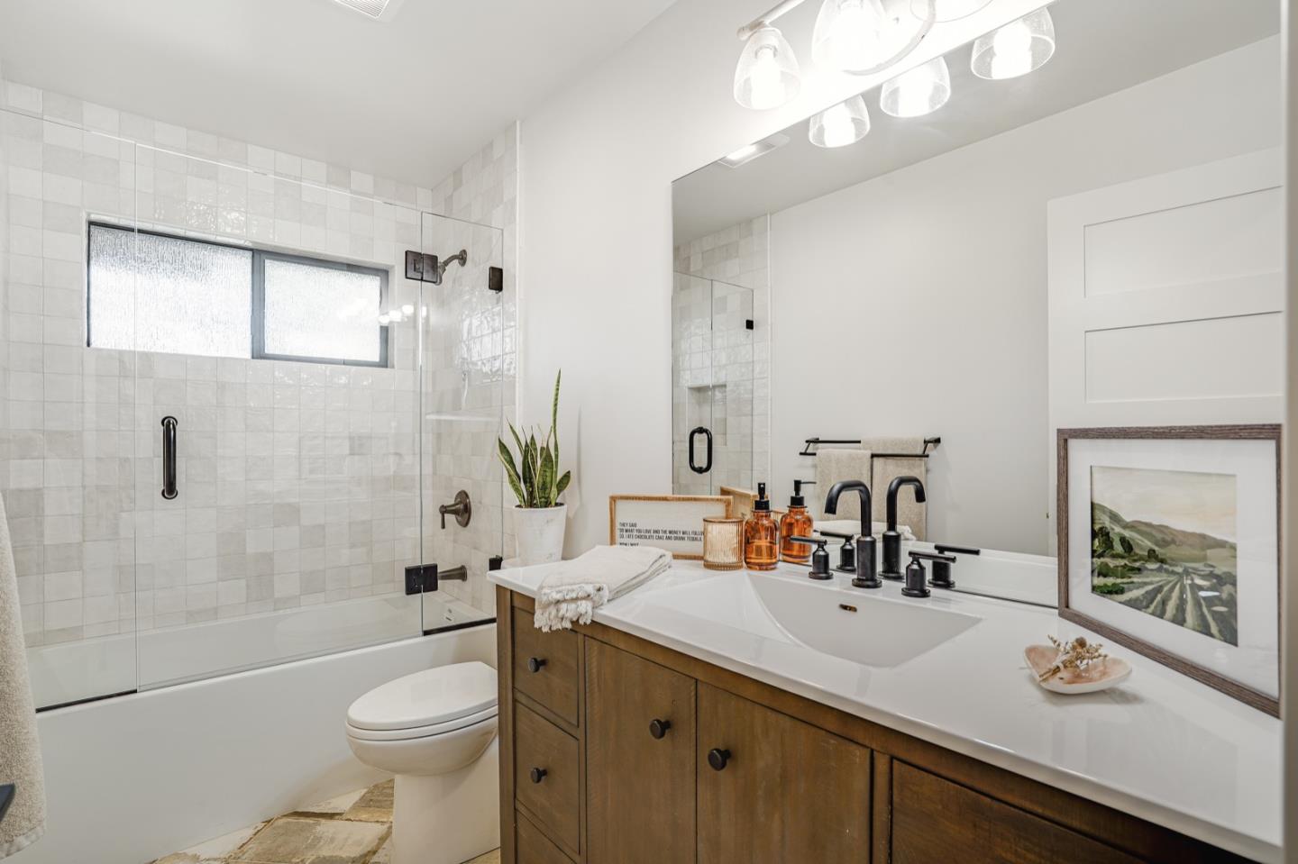 14150 Reservation Road Salinas, CA 93908 - Photo 27 of 47 a bathroom with a sink a toilet a mirror and shower