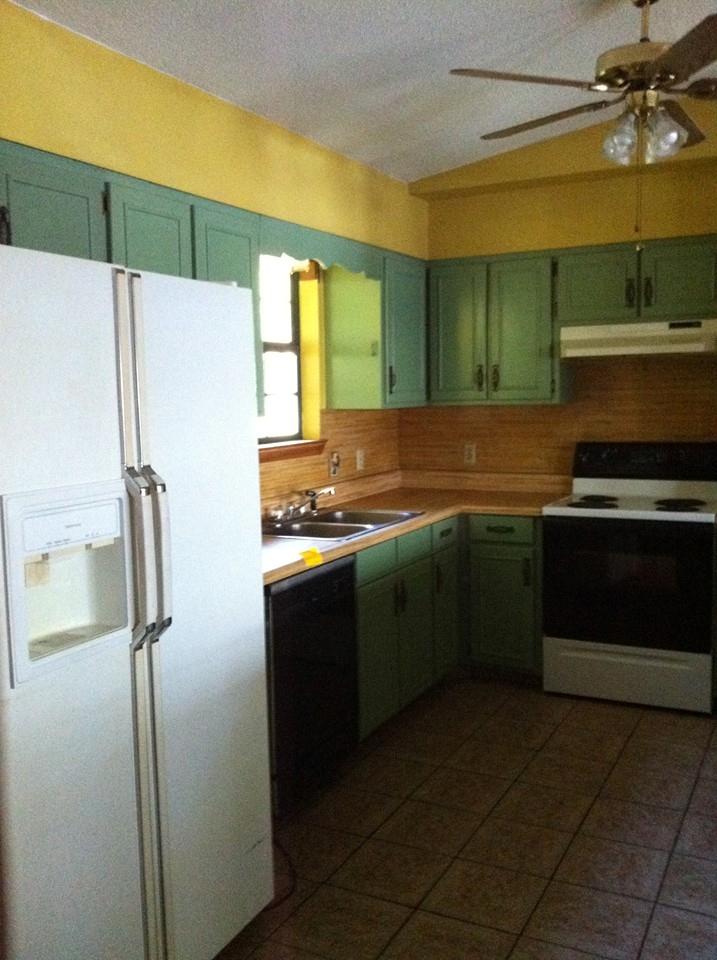 300 Wesley Road DeFuniak Springs, FL 32433 - Photo 7 of 10 a kitchen with a refrigerator a sink and a stove