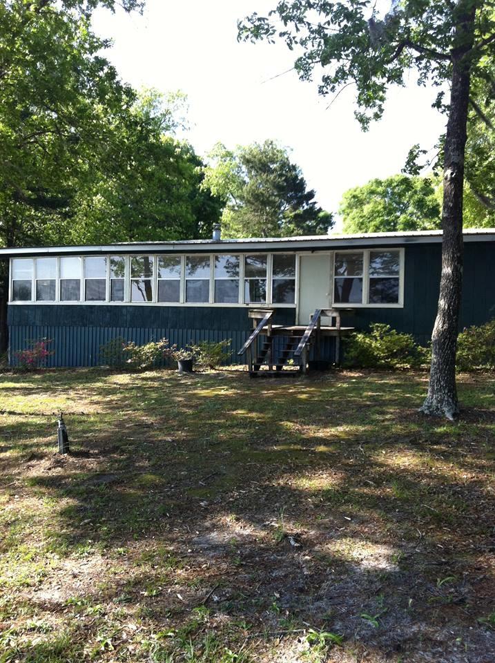 300 Wesley Road DeFuniak Springs, FL 32433 - Photo 8 of 10 a view of a swimming pool with a chair and potted plants
