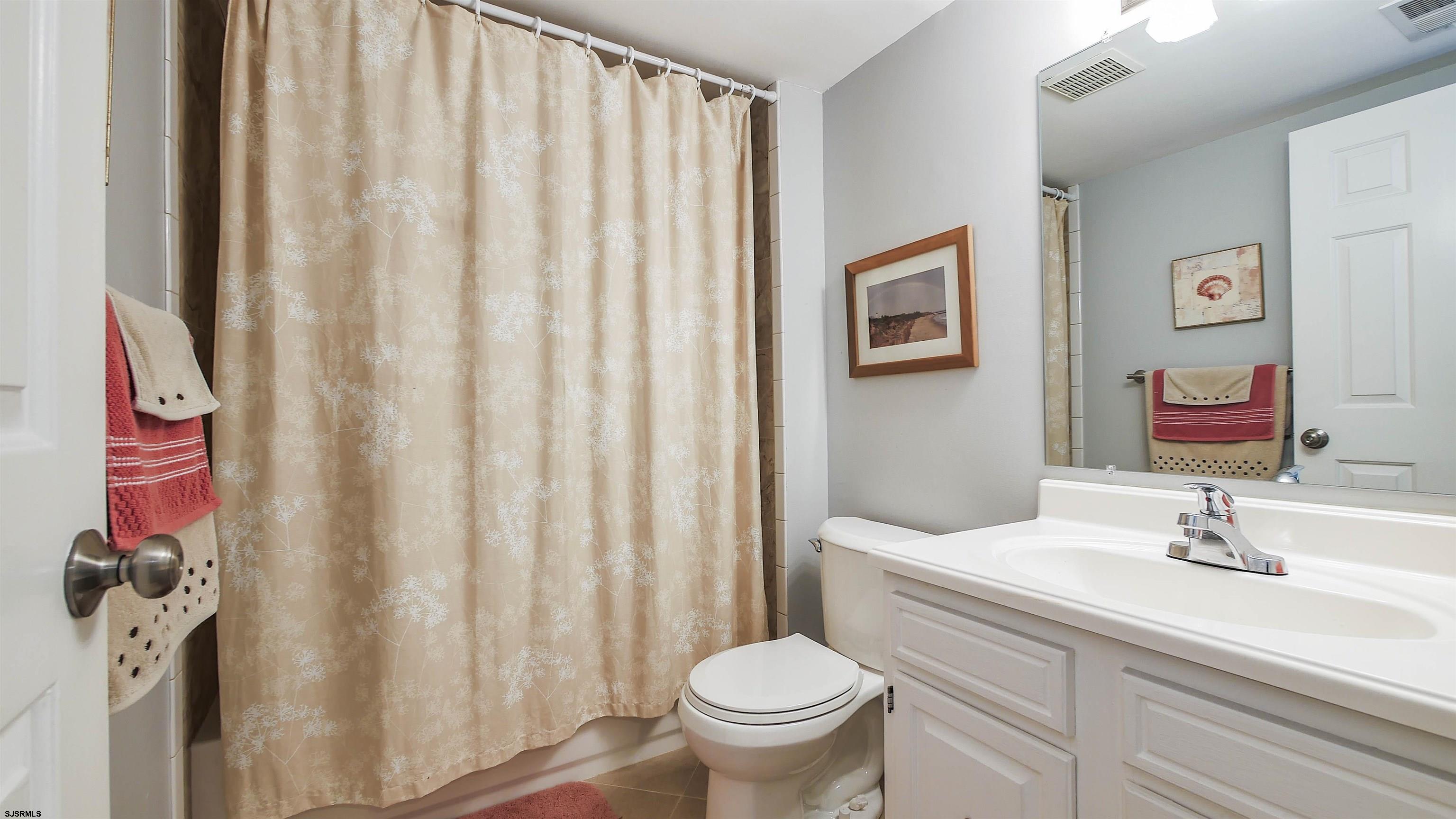 4318 West Brigantine Avenue, Unit D1 Brigantine, NJ 08203 - Photo 16 of 30 a bathroom with a sink toilet and a mirror