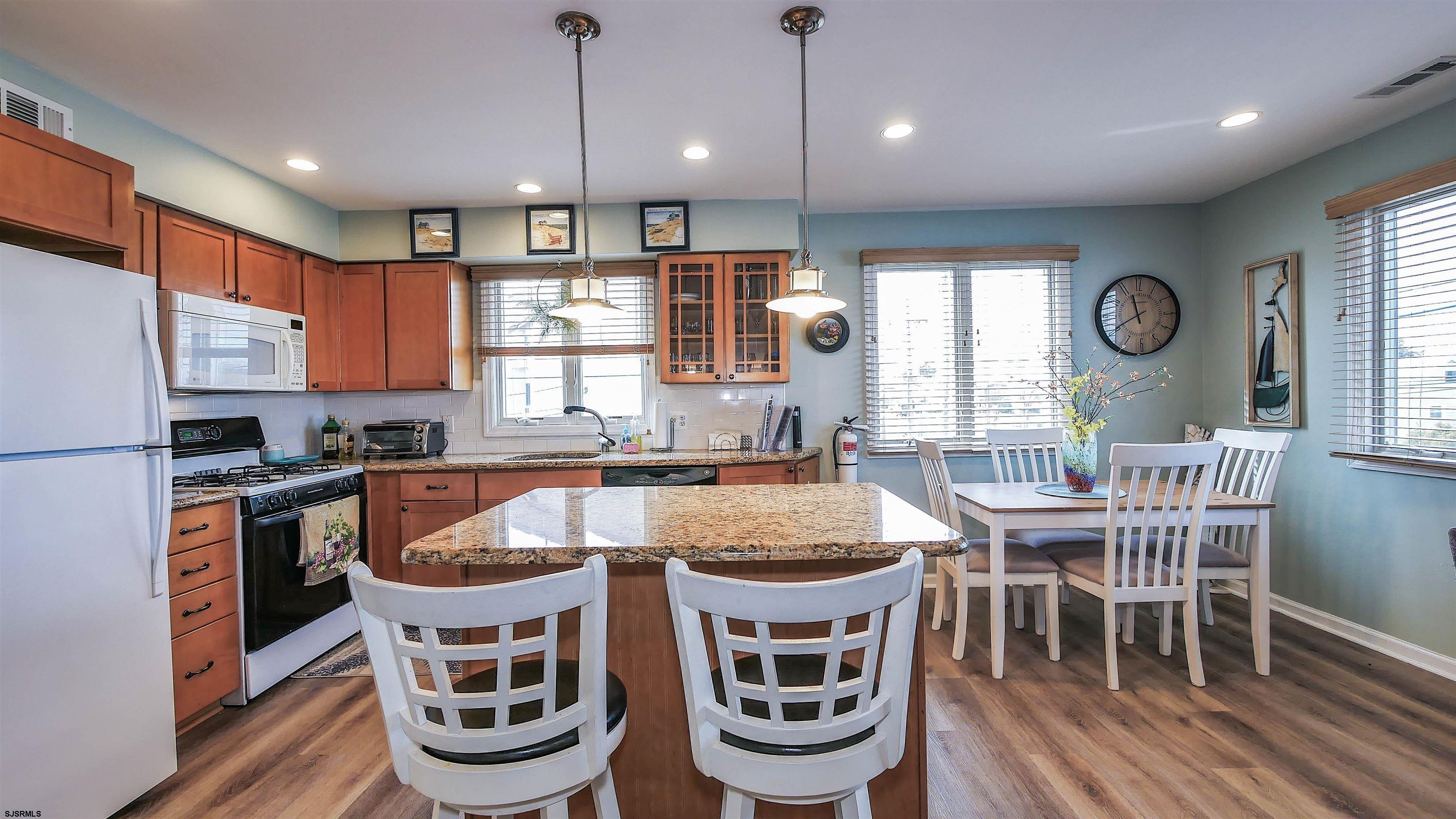 4318 West Brigantine Avenue, Unit D1 Brigantine, NJ 08203 - Photo 4 of 30 a large kitchen with a table and chairs in it