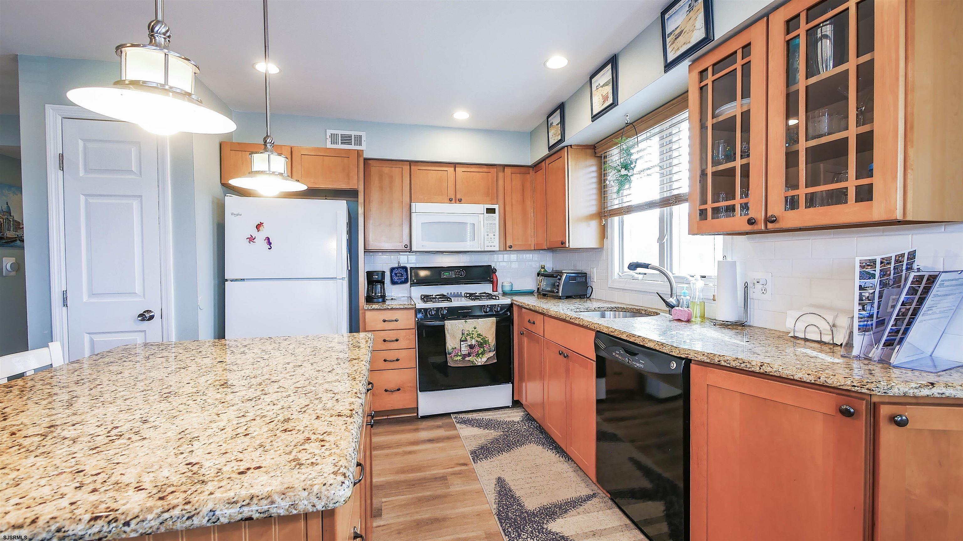 4318 West Brigantine Avenue, Unit D1 Brigantine, NJ 08203 - Photo 7 of 30 a kitchen with granite countertop a sink stove and refrigerator