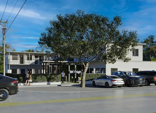 a view of a street that has couple of cars parked on the road
