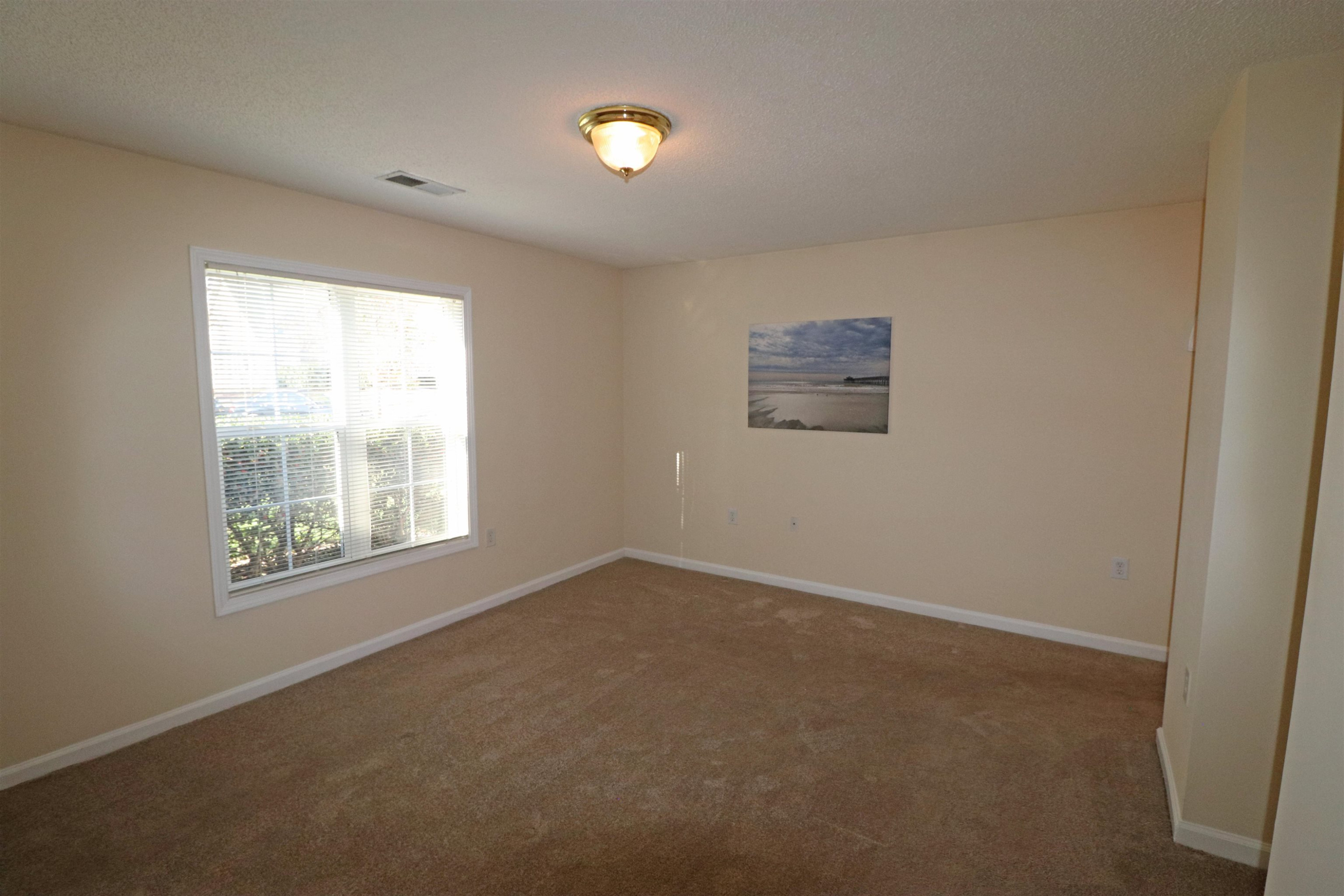 11371 Involute Place, Unit 103 Raleigh, NC 27617 - Photo 13 of 34 an empty room with a window