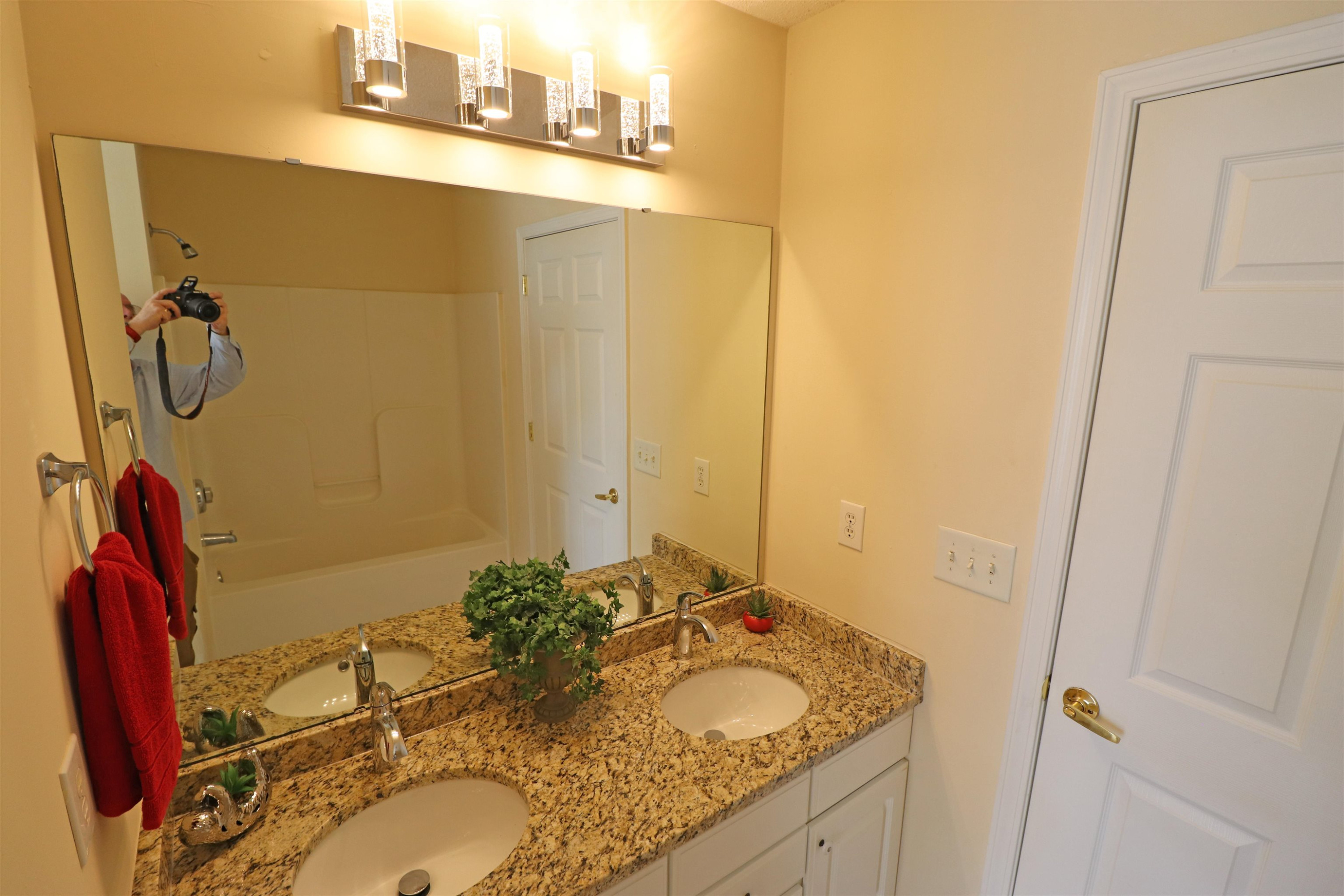 11371 Involute Place, Unit 103 Raleigh, NC 27617 - Photo 16 of 34 a bathroom with a granite countertop sink and a mirror