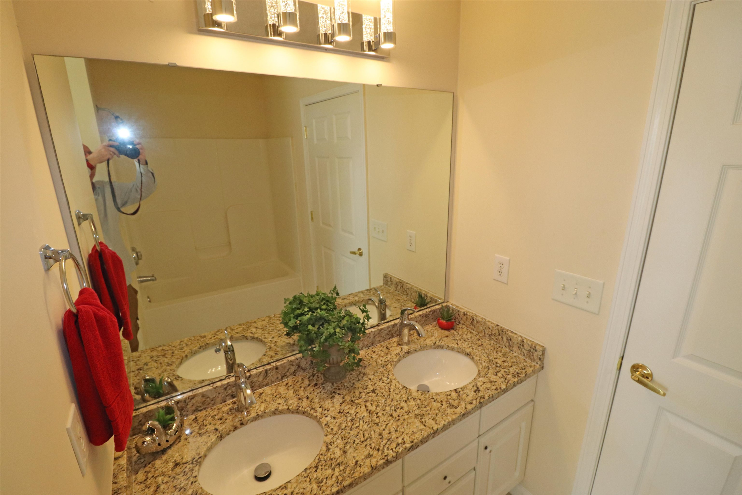 11371 Involute Place, Unit 103 Raleigh, NC 27617 - Photo 17 of 34 a bathroom with a sink and a mirror