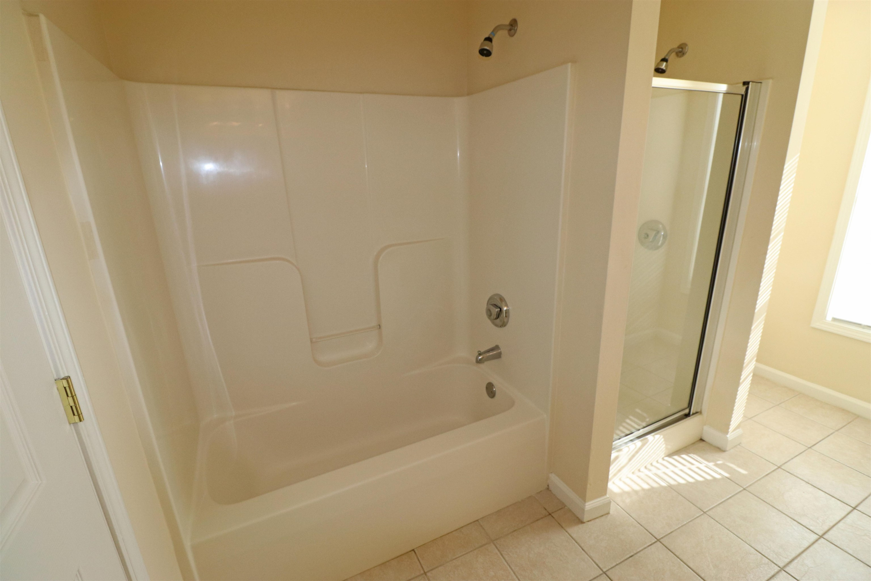 11371 Involute Place, Unit 103 Raleigh, NC 27617 - Photo 18 of 34 a bathroom with a bathtub