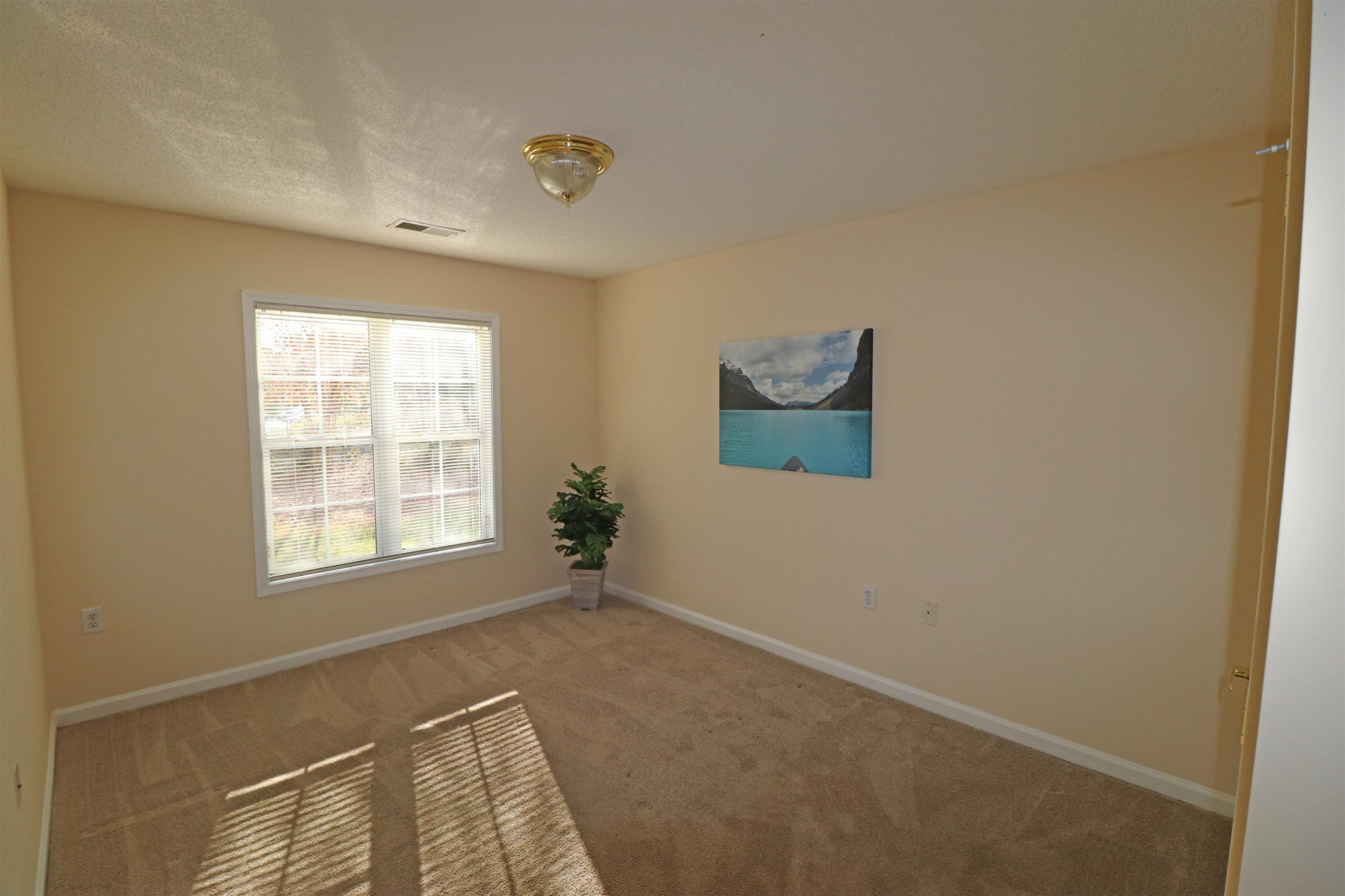 11371 Involute Place, Unit 103 Raleigh, NC 27617 - Photo 20 of 34 a view of an empty room with a window