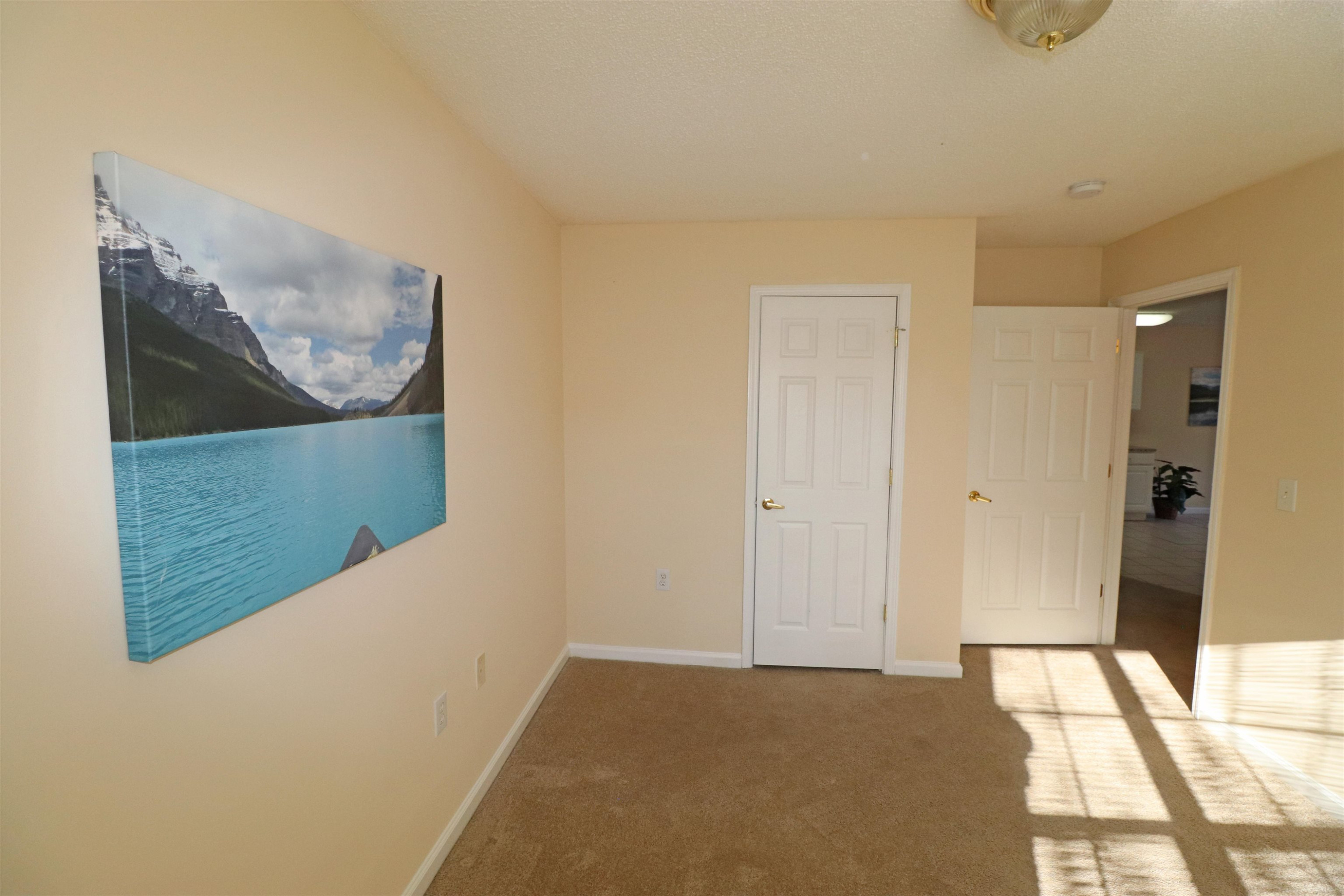 11371 Involute Place, Unit 103 Raleigh, NC 27617 - Photo 21 of 34 a view of a hallway to rooms