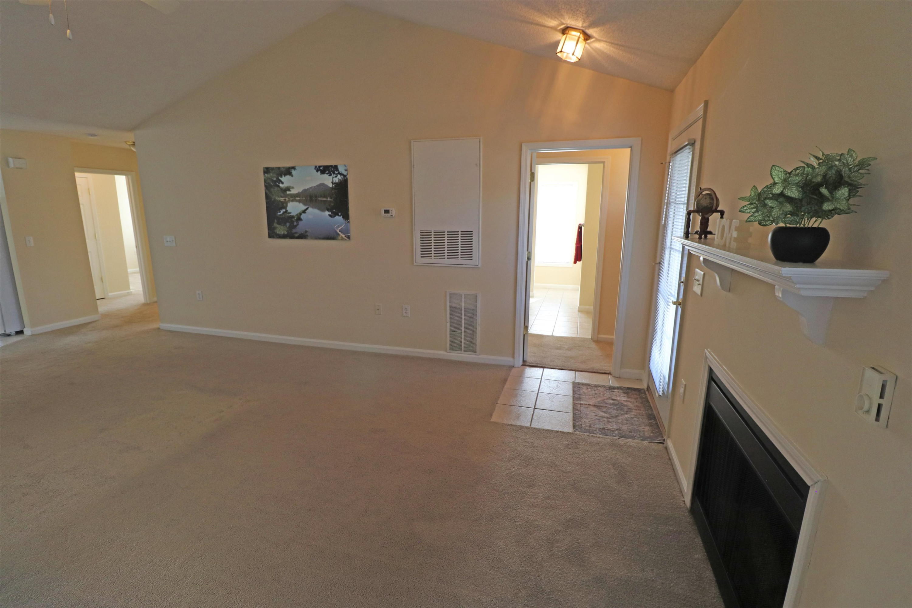 11371 Involute Place, Unit 103 Raleigh, NC 27617 - Photo 3 of 34 a view of an empty room with glass door and a window