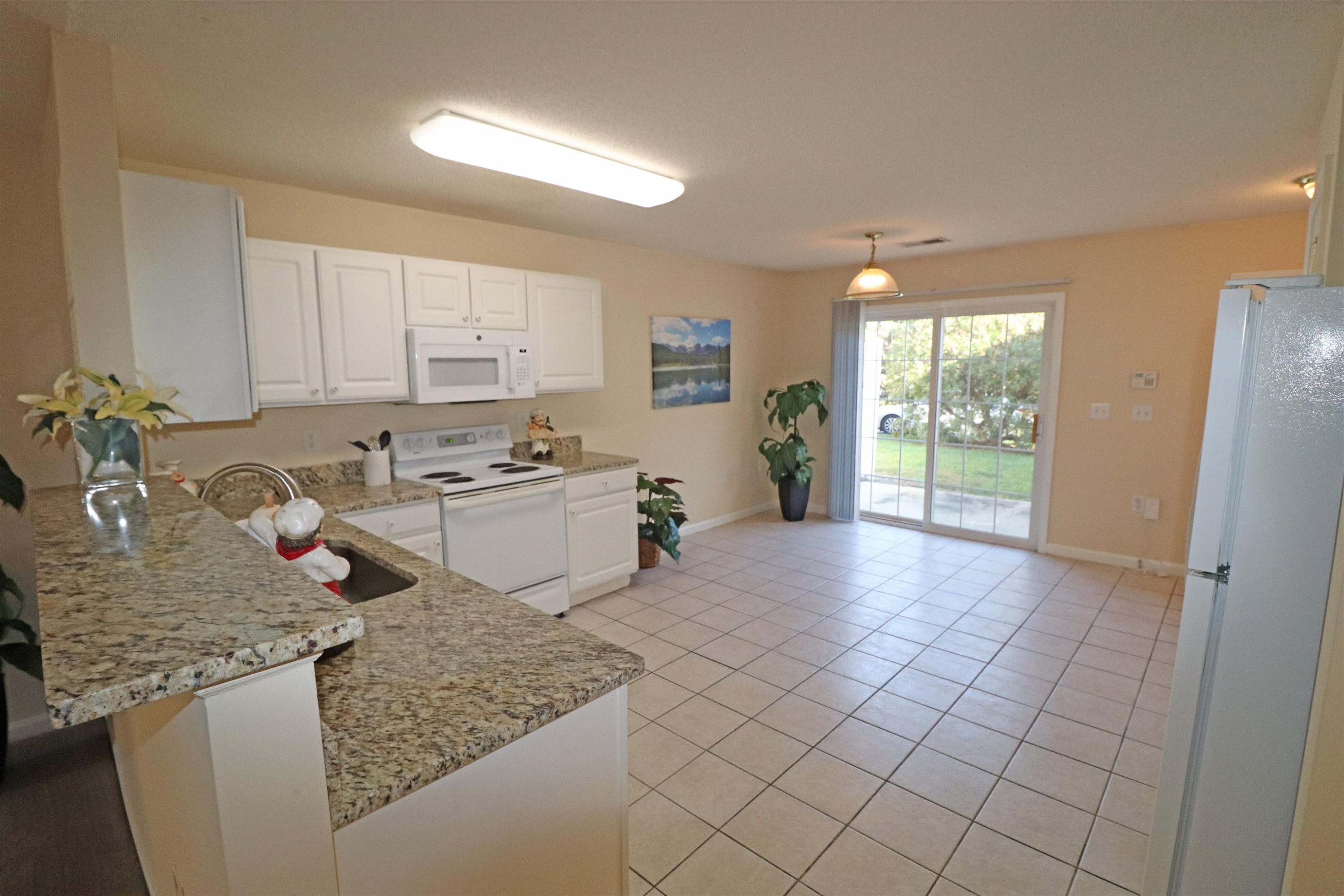 11371 Involute Place, Unit 103 Raleigh, NC 27617 - Photo 5 of 34 a kitchen with stainless steel appliances granite countertop a sink stove and refrigerator