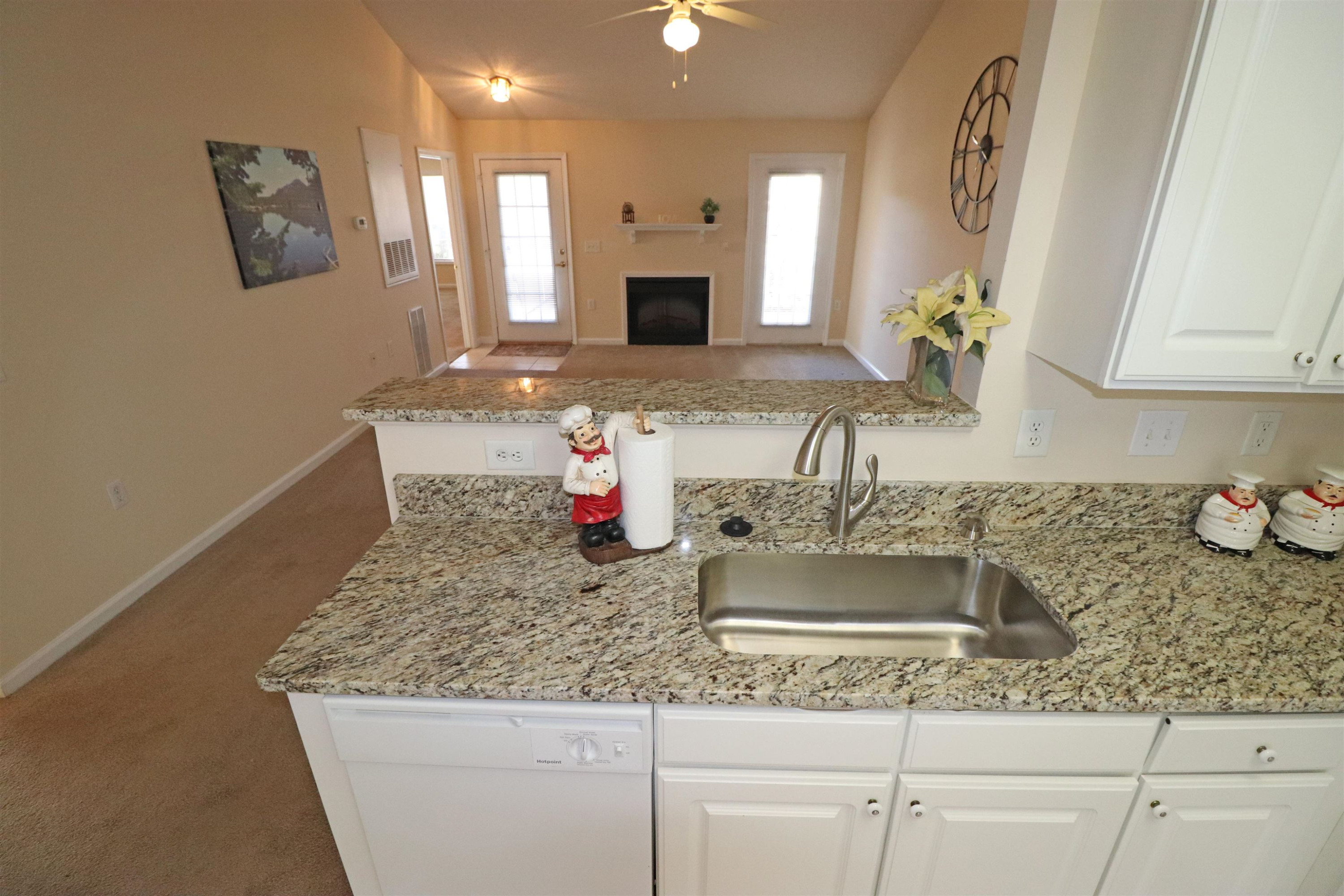 11371 Involute Place, Unit 103 Raleigh, NC 27617 - Photo 9 of 34 a kitchen with sink granite counter tops and a stove