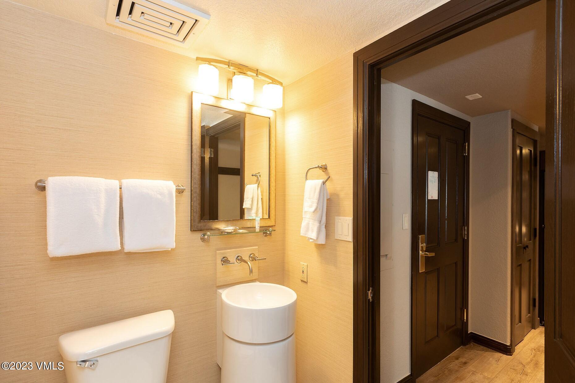 210 Offerson Road, Unit 209 WEEK 30 Beaver Creek, CO 81620 - Photo 12 of 27 a bathroom with a toilet a sink and mirror
