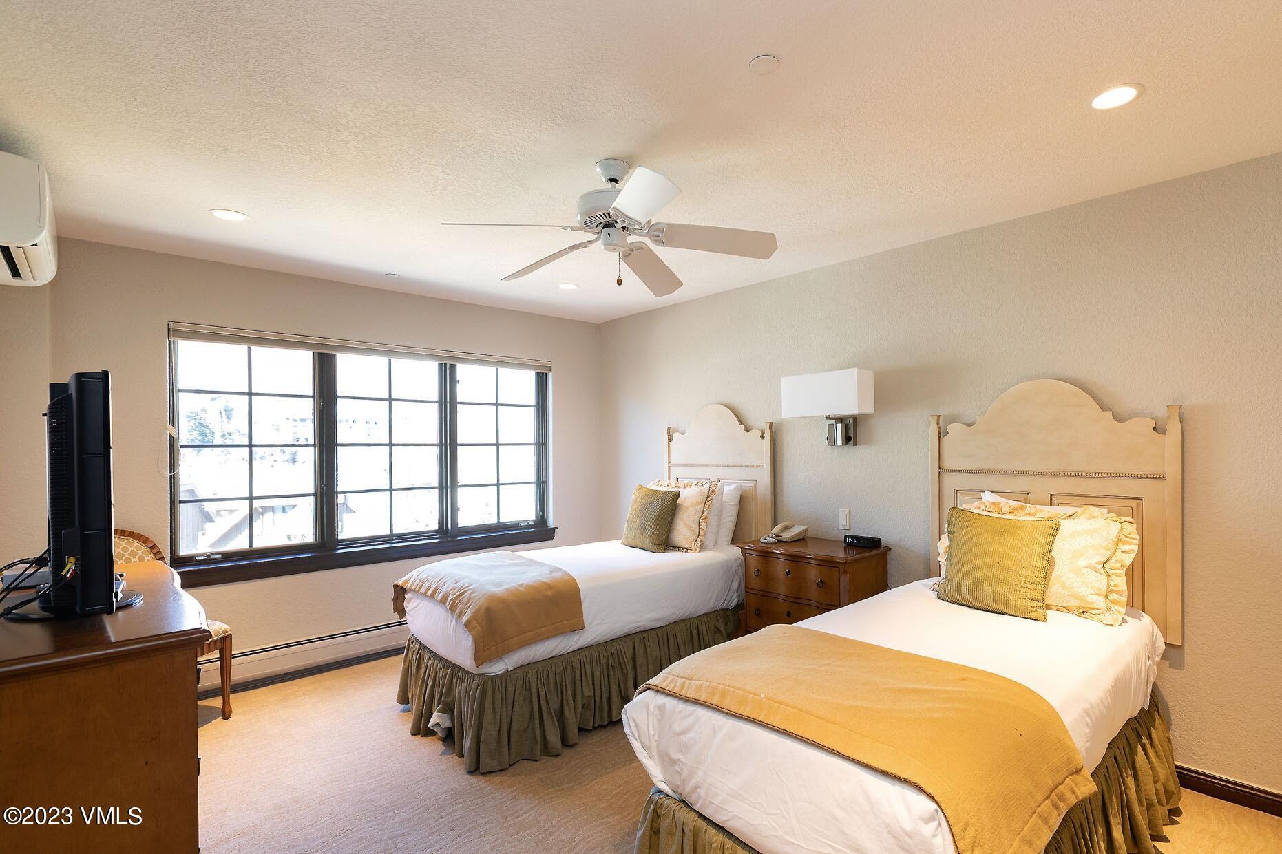 210 Offerson Road, Unit 209 WEEK 30 Beaver Creek, CO 81620 - Photo 18 of 27 a bedroom with two beds and a chandelier