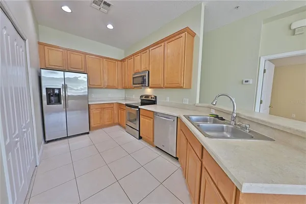 a kitchen with granite countertop a sink stainless steel appliances and cabinets