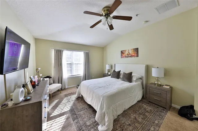 a bedroom with a bed and a chandelier