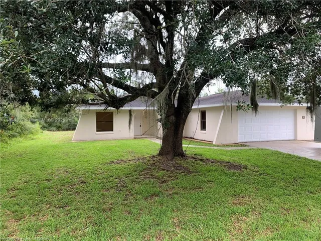 a view of a backyard with large trees