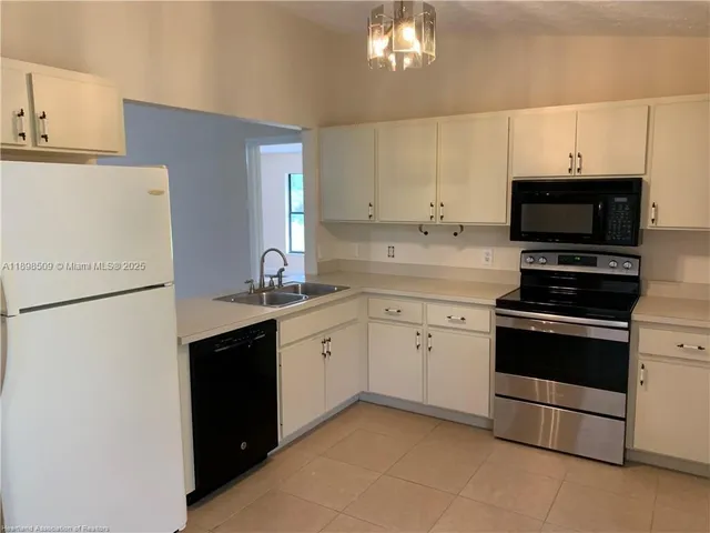 a kitchen with stainless steel appliances a stove microwave and sink