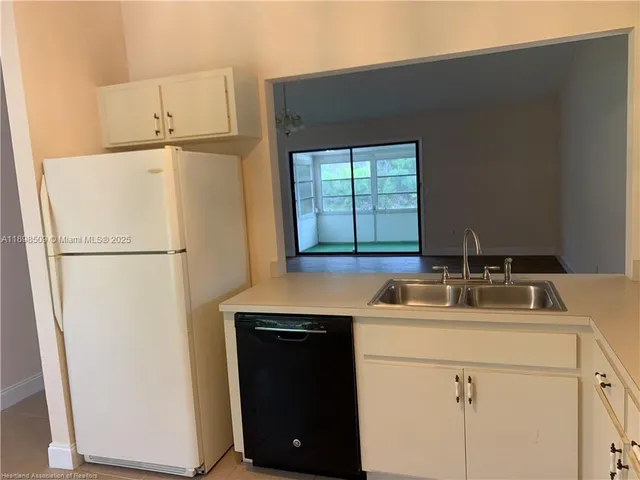 a kitchen with a sink and a refrigerator