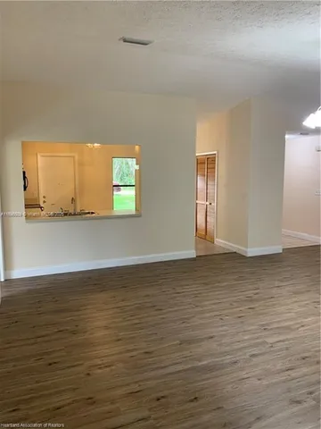 a view of a room with wooden floor and window