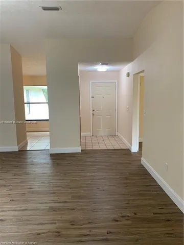 a view of wooden floor and windows in a room