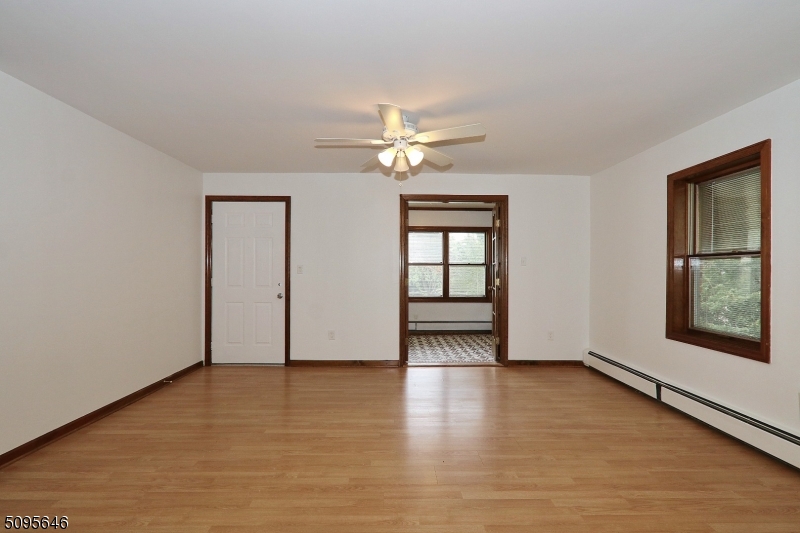 2 Gates Avenue, Unit A Summit, NJ 07901 - Photo 11 of 19 an empty room with wooden floor chandelier fan and windows