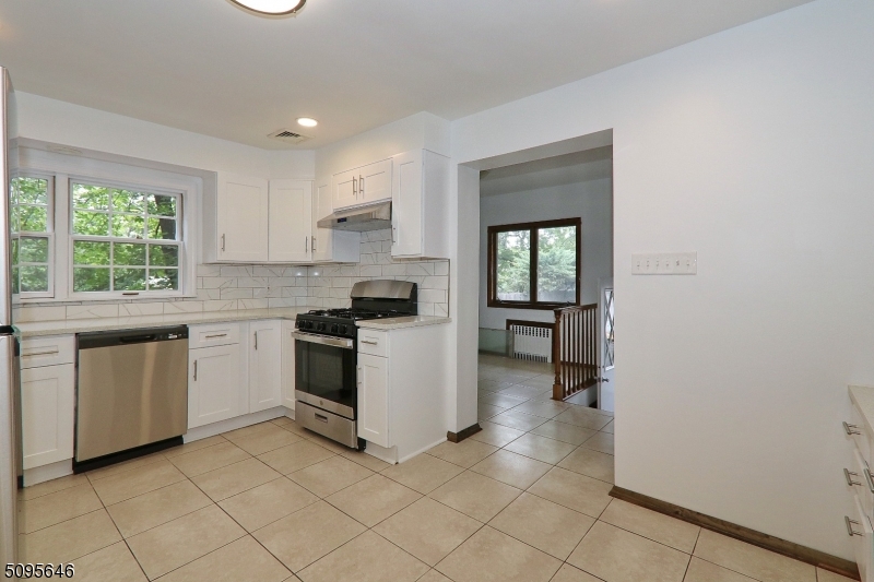 2 Gates Avenue, Unit A Summit, NJ 07901 - Photo 2 of 19 a kitchen with white cabinets and white appliances