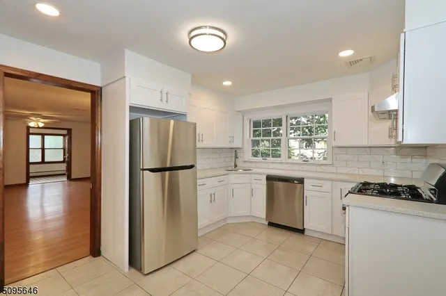 a kitchen with a refrigerator and a stove top oven