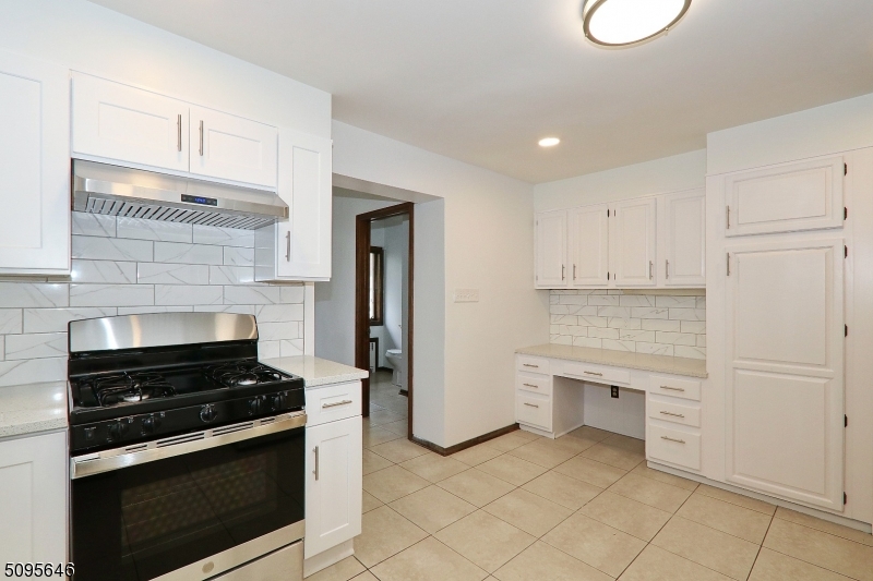 2 Gates Avenue, Unit A Summit, NJ 07901 - Photo 4 of 19 a kitchen with white cabinets and appliances