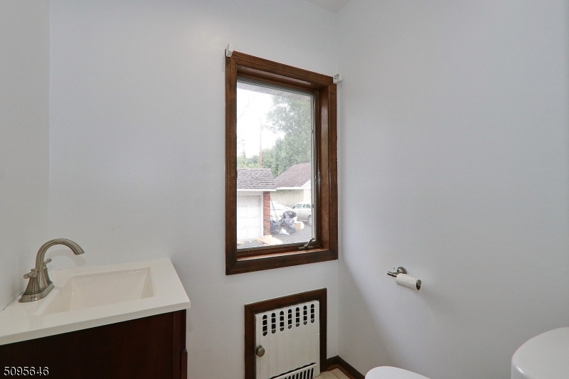 2 Gates Avenue, Unit A Summit, NJ 07901 - Photo 6 of 19 a bathroom with a sink mirror and a toilet