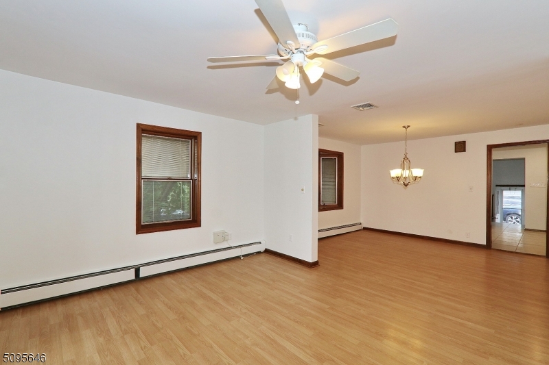 2 Gates Avenue, Unit A Summit, NJ 07901 - Photo 9 of 19 an empty room with wooden floor and ceiling fan