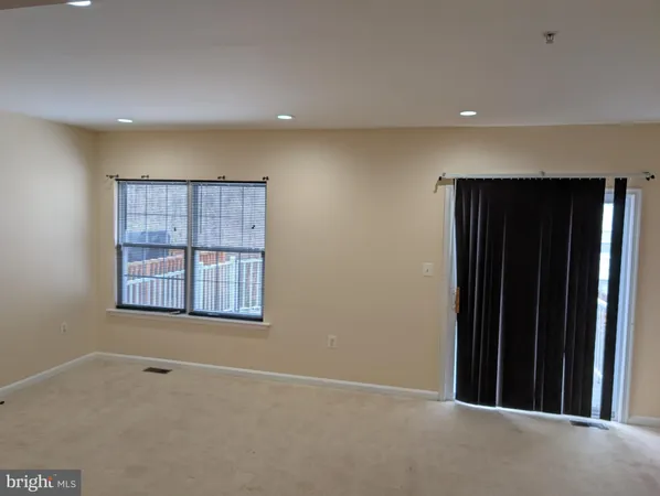 a view of an empty room with a fireplace