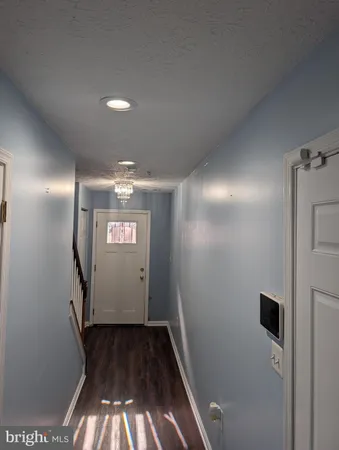 a living room with flat screen tv flat screen tv and gym equipment