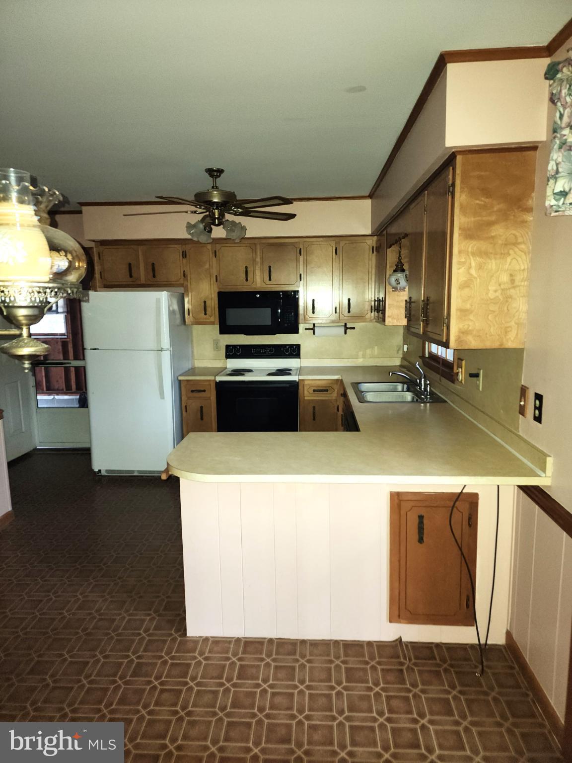 9310 Romancoke Road Stevensville, MD 21666 - Photo 13 of 35 a kitchen with a sink and a stove top oven