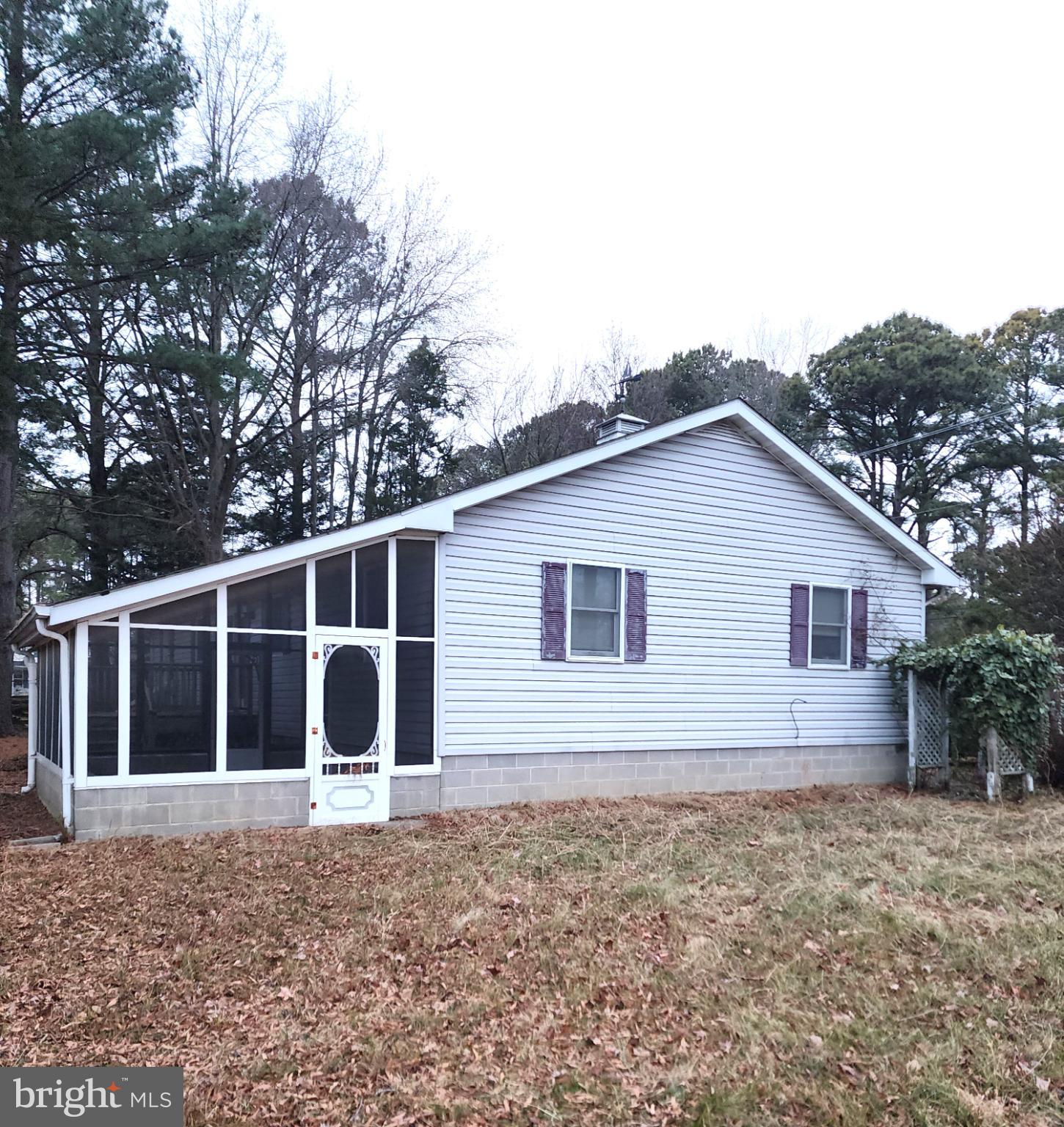 9310 Romancoke Road Stevensville, MD 21666 - Photo 14 of 35 a house with trees in the background