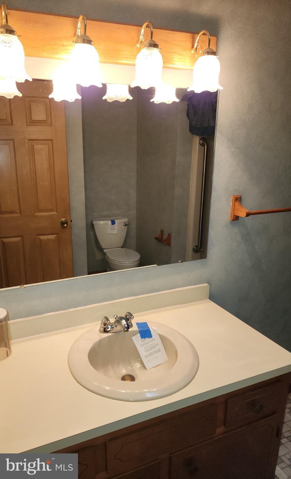 9310 Romancoke Road Stevensville, MD 21666 - Photo 16 of 35 a bathroom with a sink and a mirror